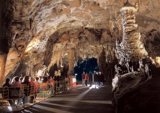 Explore Postojna Caves either by foot or train in Slovenia.