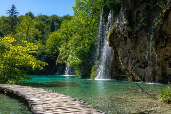 Plitivice Lakes National Park is best explored on foot and has scenic and leisurely walking trails and boardwalks suspended above turquoise waters. 