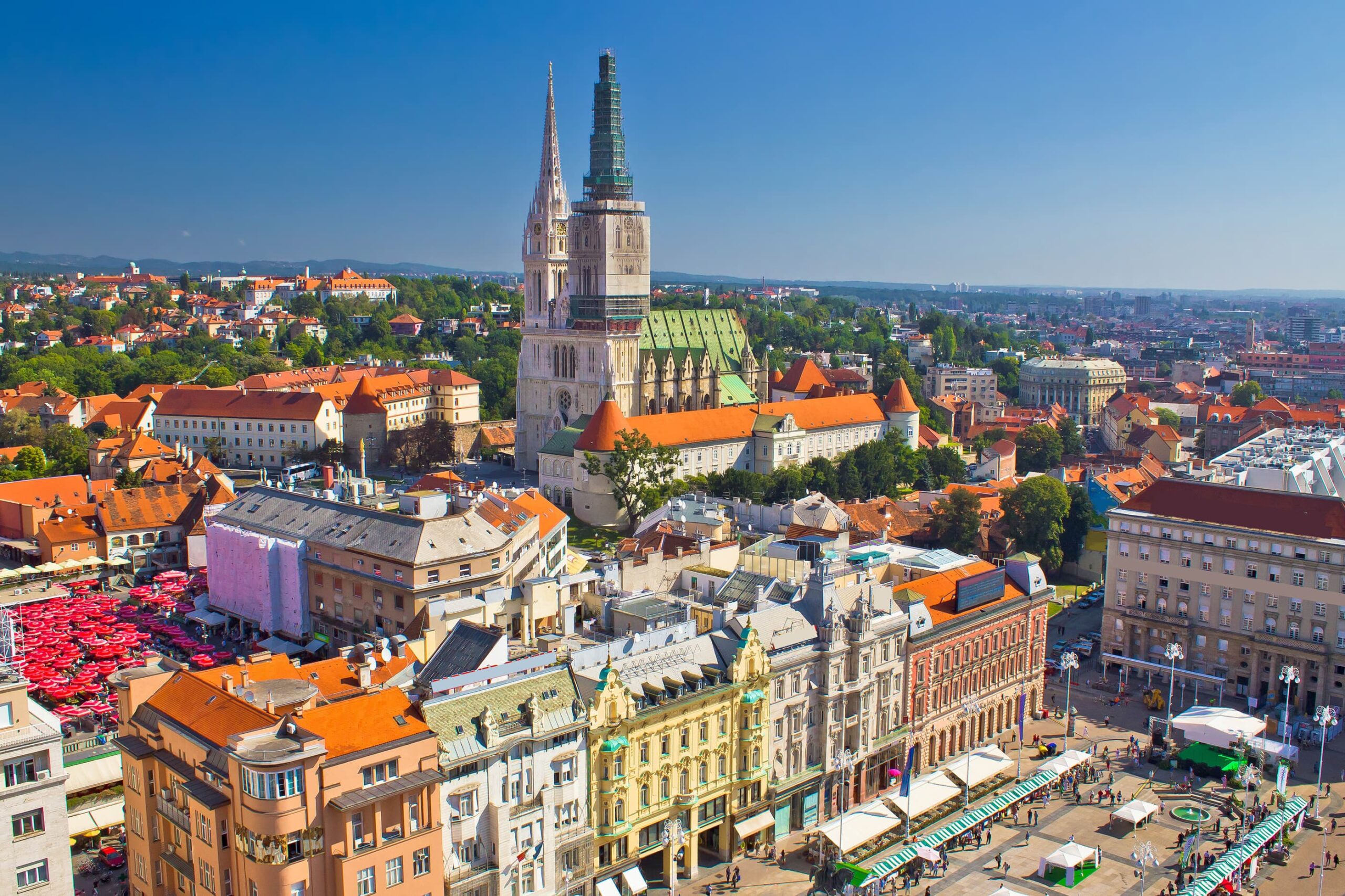 Ban Jelacic Square, the main square in the heart of Zagreb with the Zagreb Cathedral and red-umbrella Dolac Markets in the background.